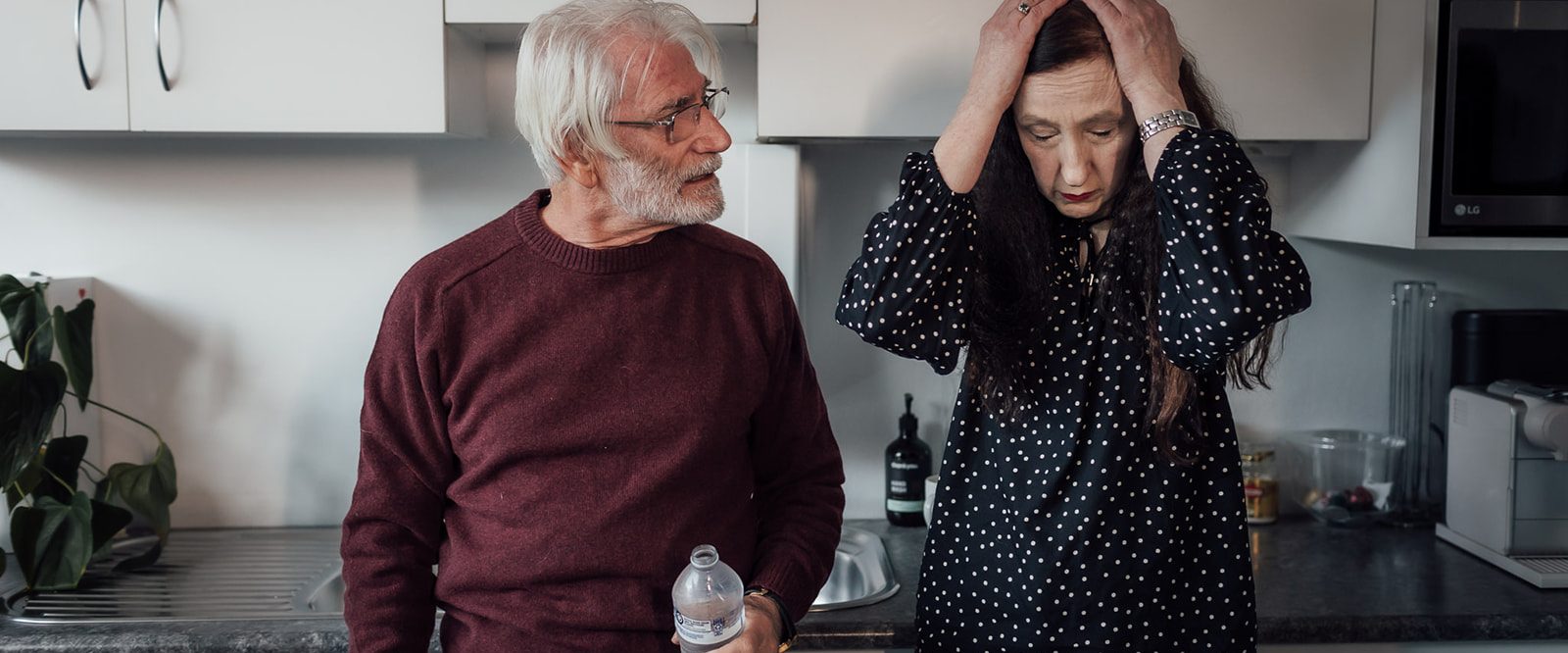 A man and a woman having an argument in a kitchen.